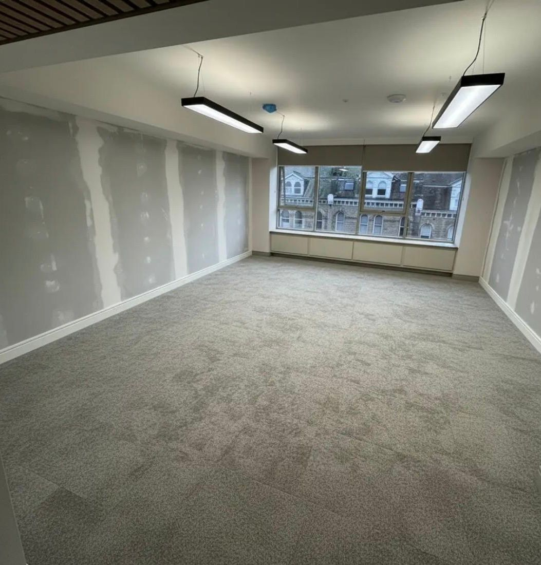 Commercial interior refurbishment with new lighting and carpet