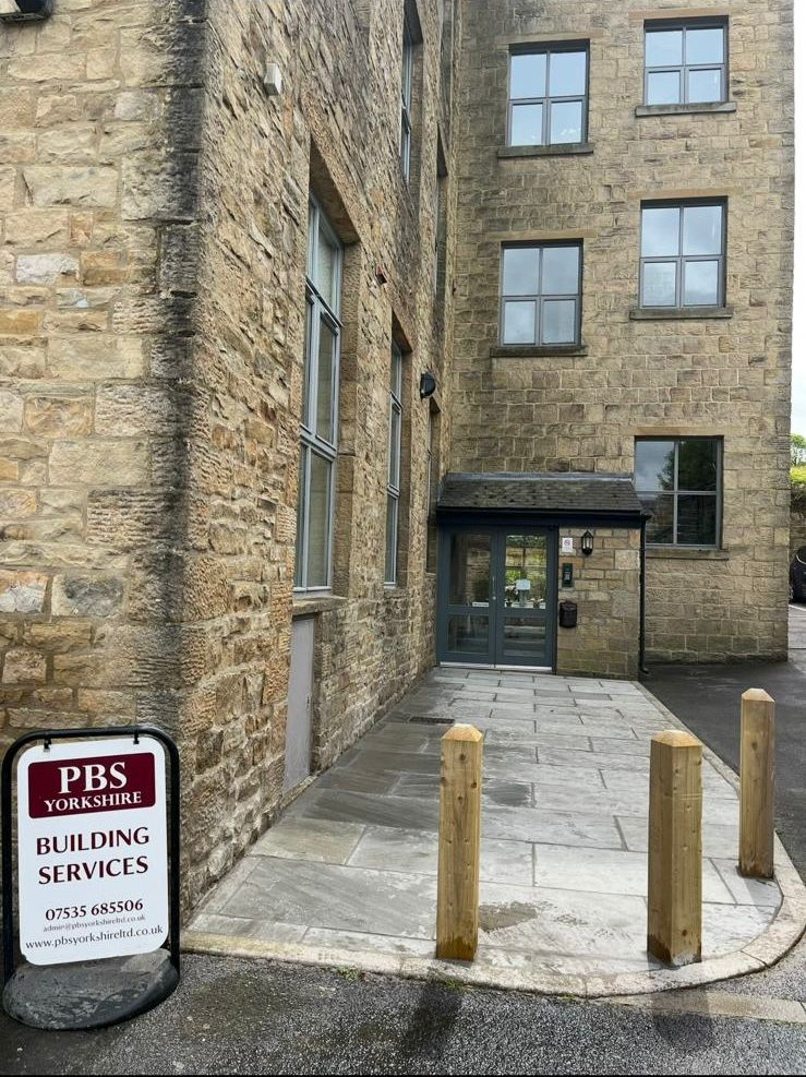Stone building entrance with PBS signage