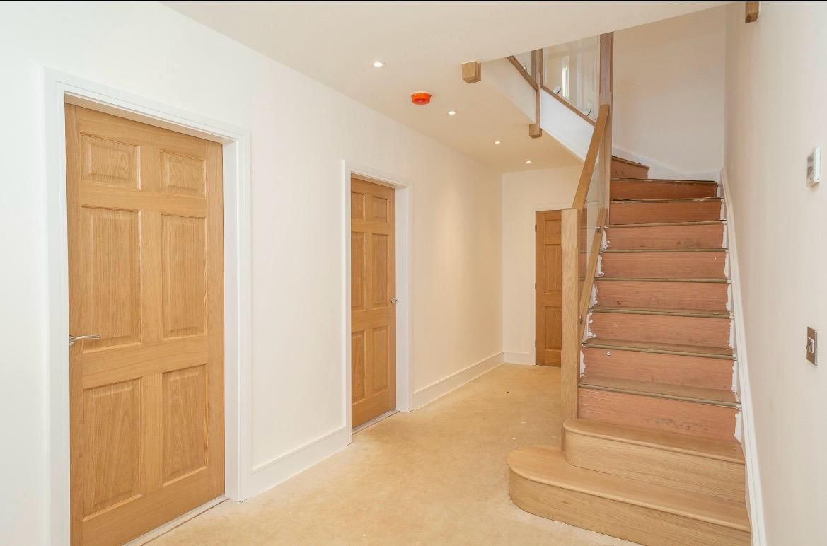 Interior hallway with oak doors and stairs